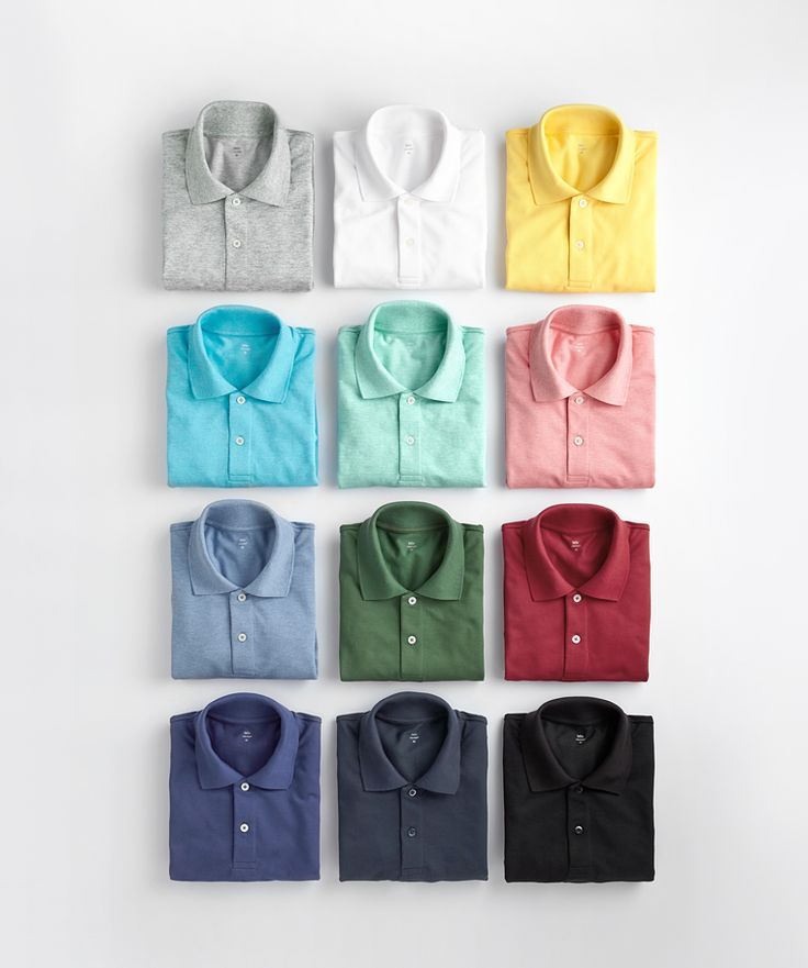 A neatly arranged display of twelve folded polo shirts in various colors, including gray, white, yellow, blue, green, pink, red, and black, on a light background.